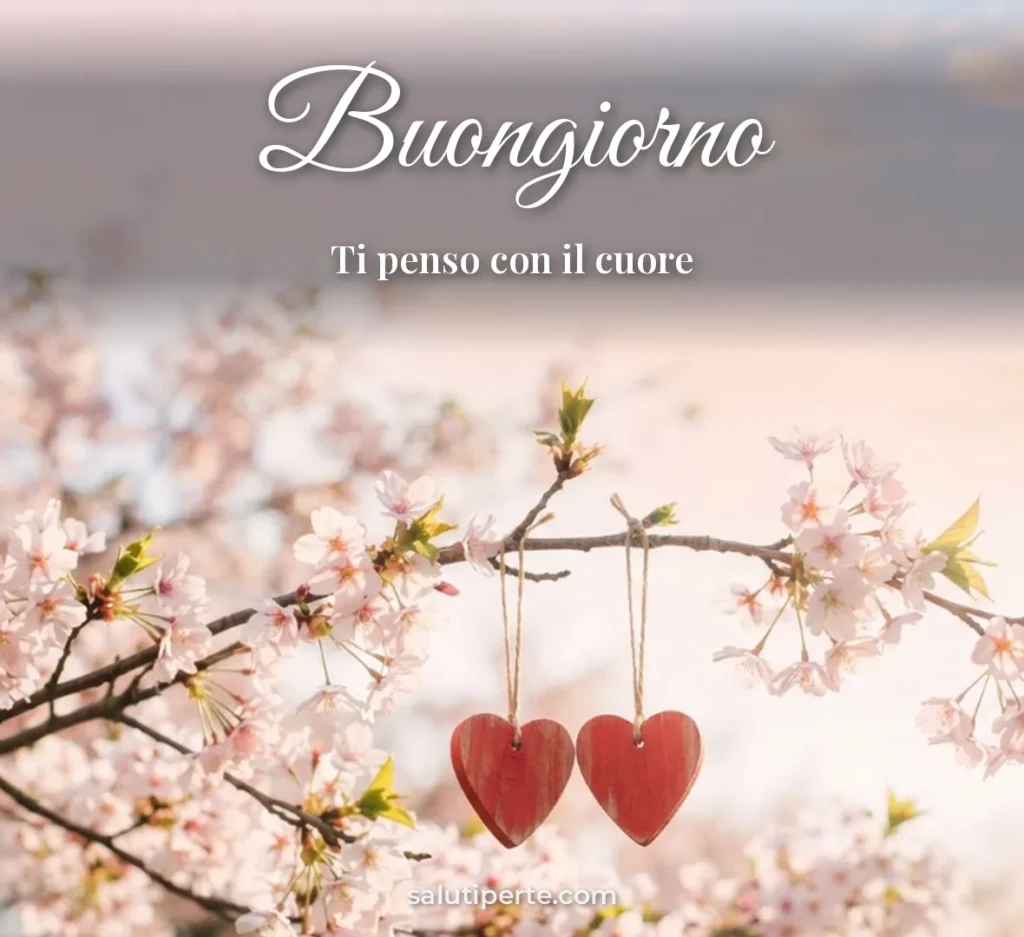 Due cuori appesi a un ramo fiorito